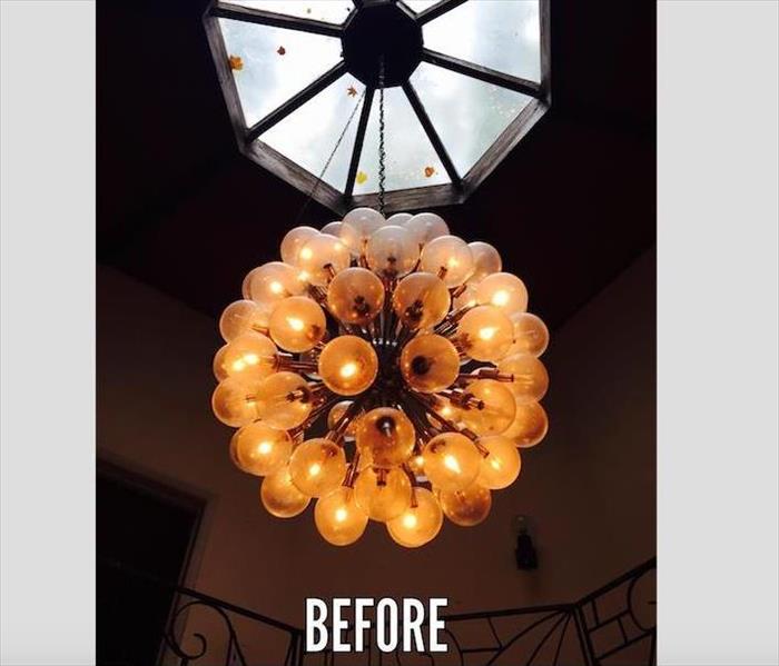 large glass ball chandelier before cleaning