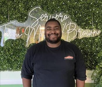 Young man standing with a Servpro shirt on