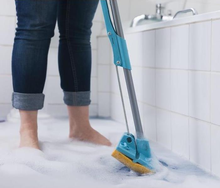 Woman mopping water